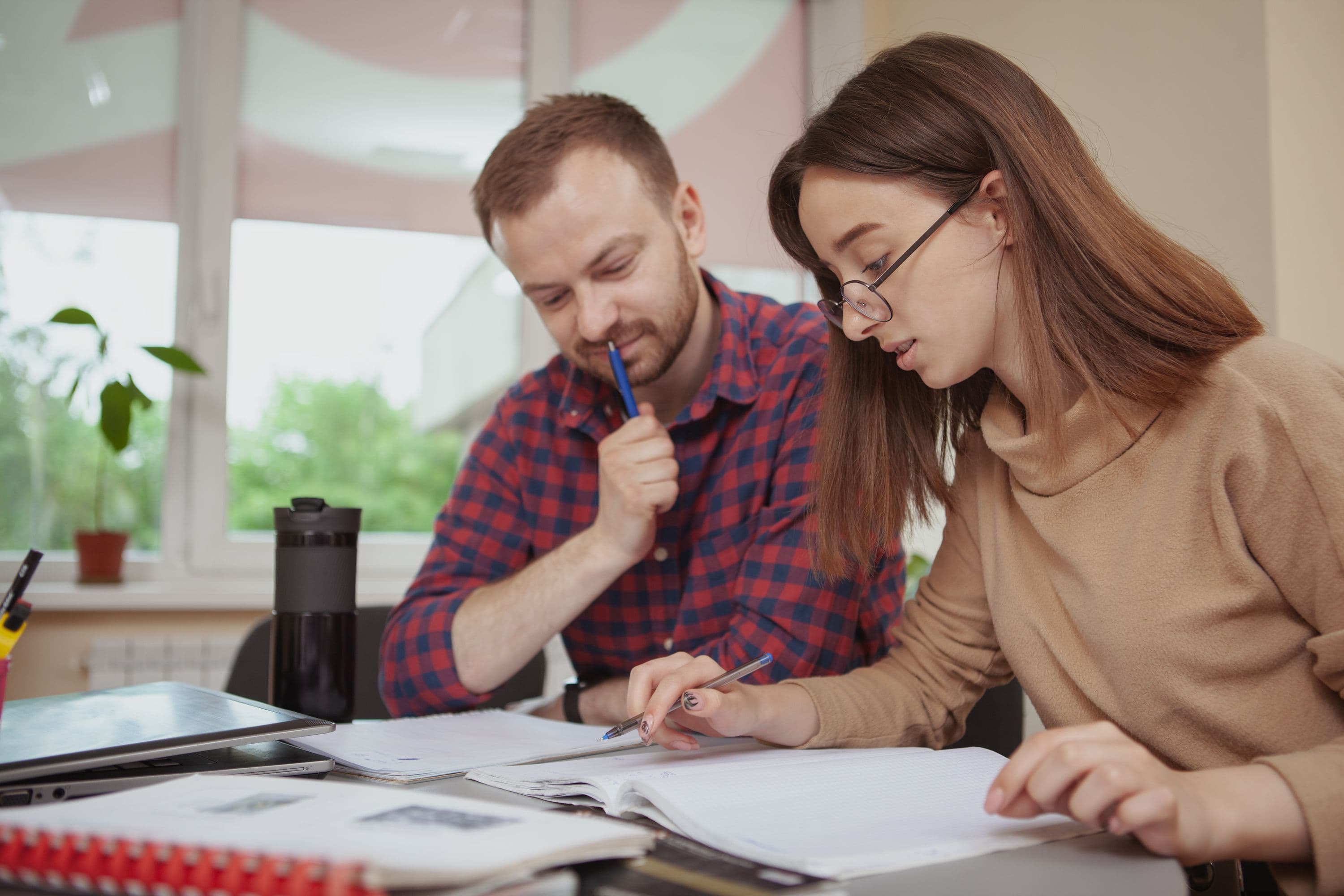 lovely-young-teenage-girl-working-project-with-her-teacher