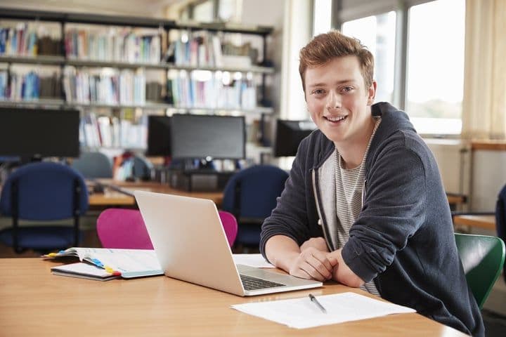 portrait-male-student-working-laptop-college-library_720